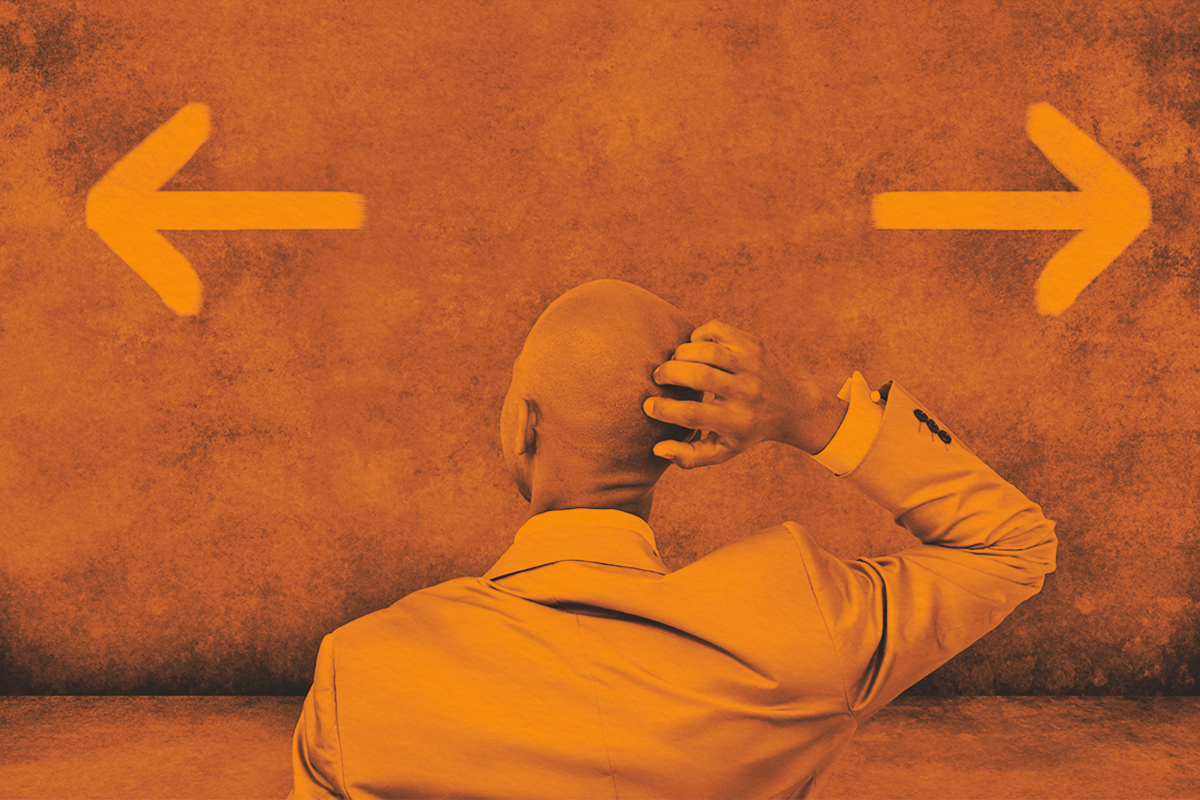 Man looking at arrows, trying to make the right chouce