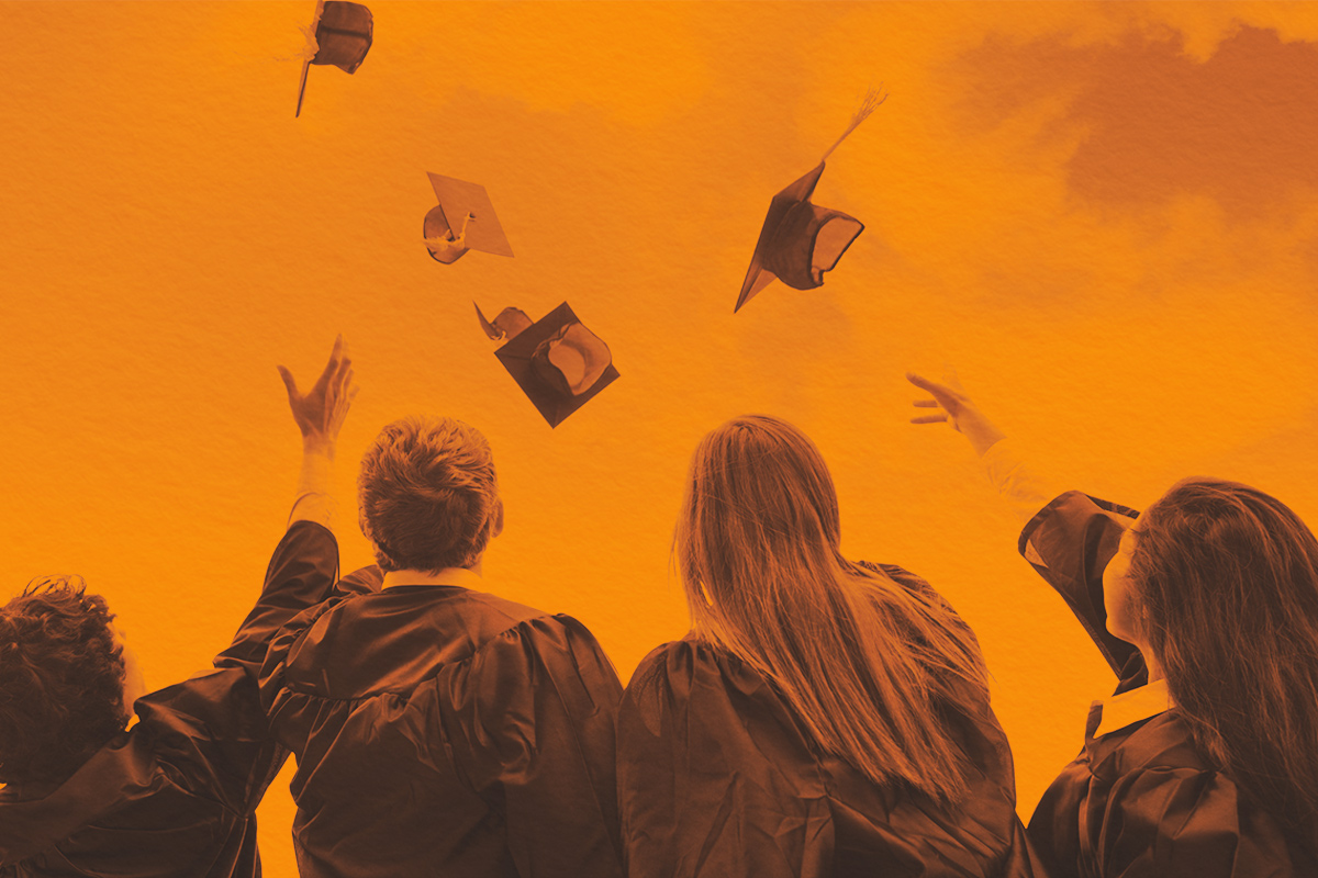 group of college graduates throwing their hats in celebration