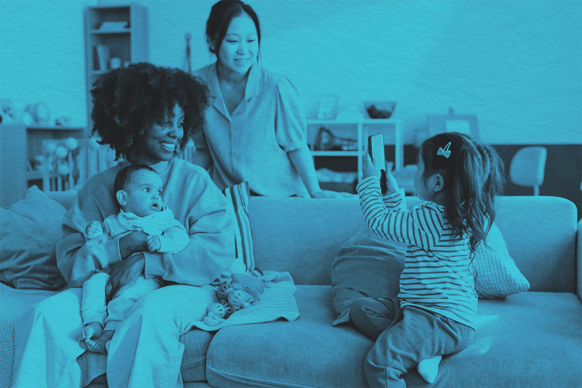 Two moms playing with their kids at home