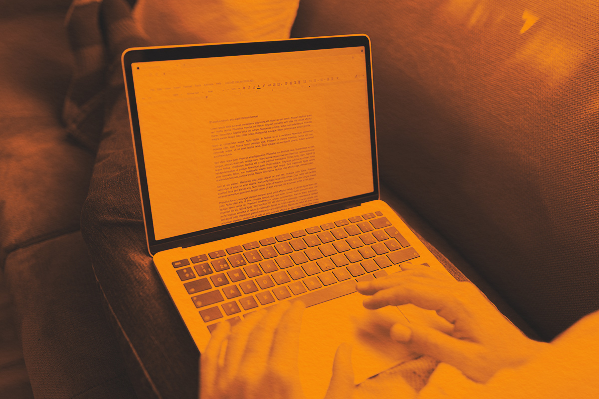 Person working on writing a report on computer