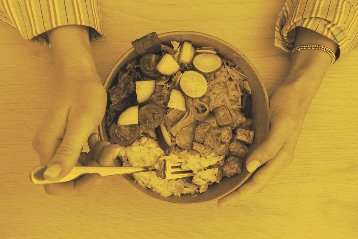Overhead view of young woman eating a meal