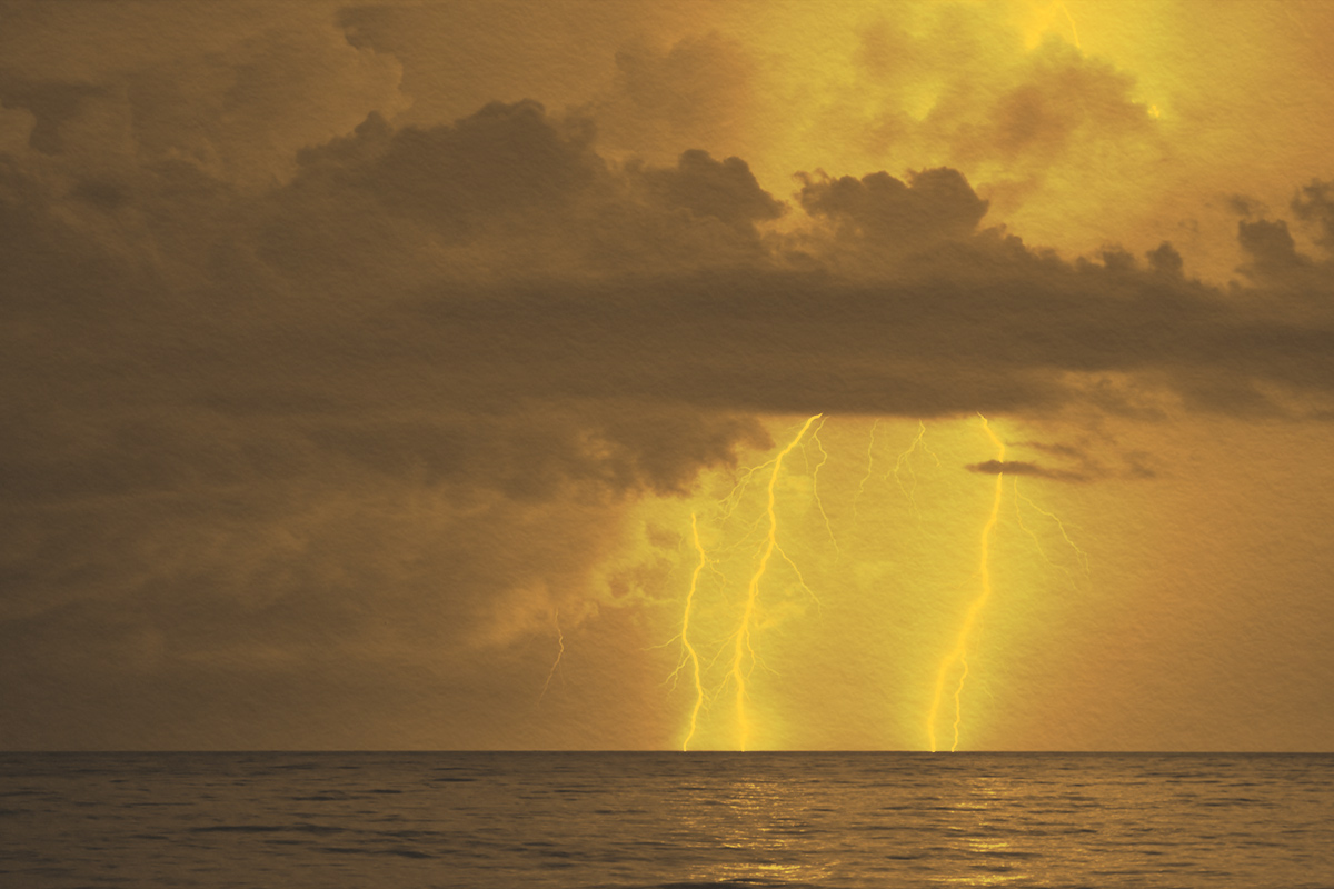 Clouds and lightning strikes over the ocean