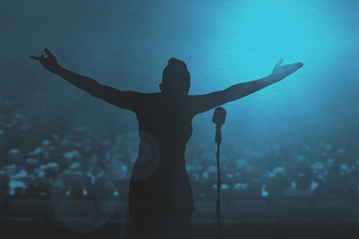 Women bowing on stage after a concert under bright spotlights