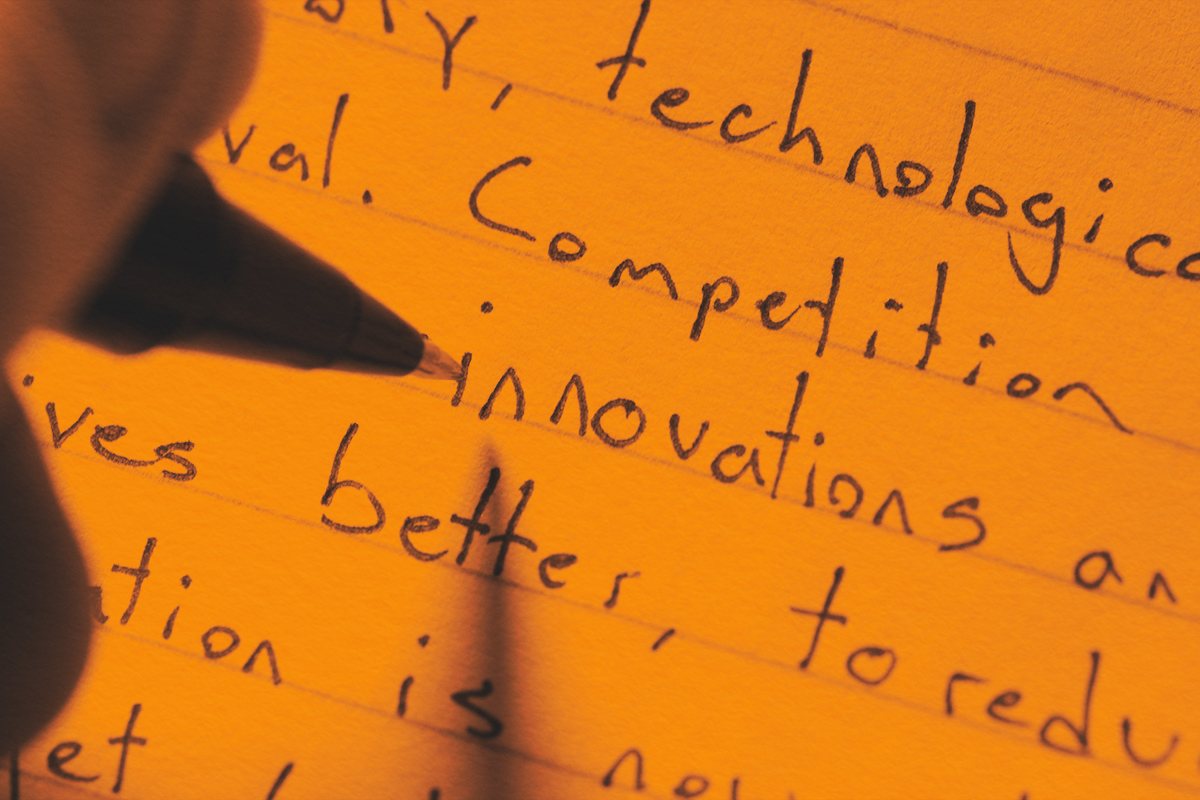 Close-up of a sentence being written with a comma.