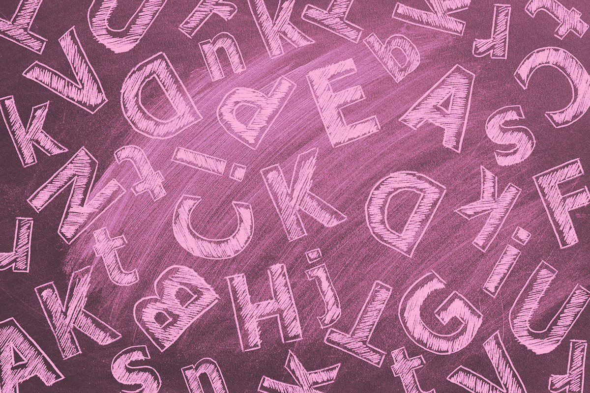 Uppercase and lowercase letters written in chalk