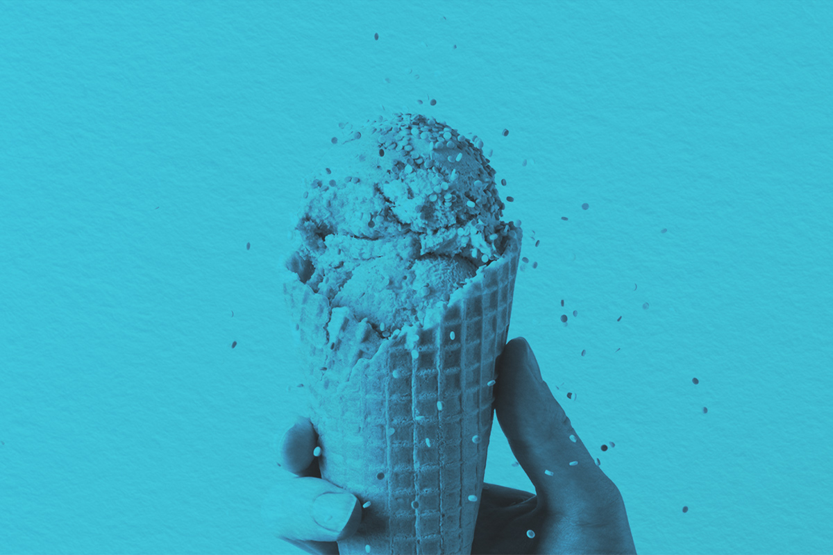 Close-up of holding ice cream with falling sprinkles in waffle cone