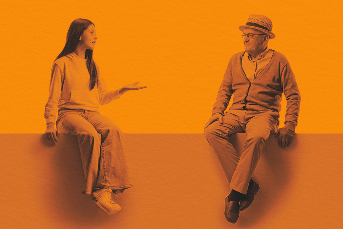Teenage girl sitting on a panel and talking to an older man