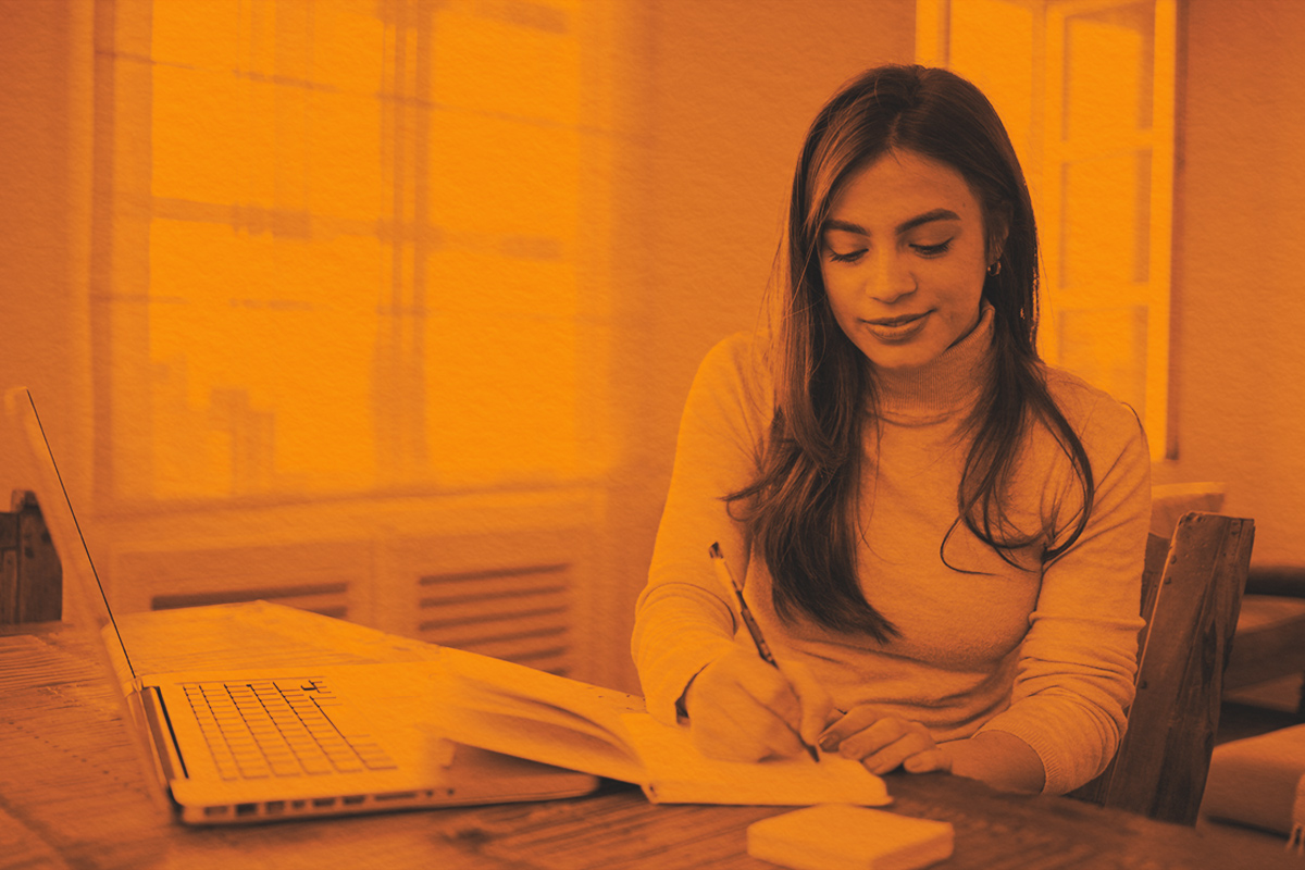 Adult woman writing in notebook