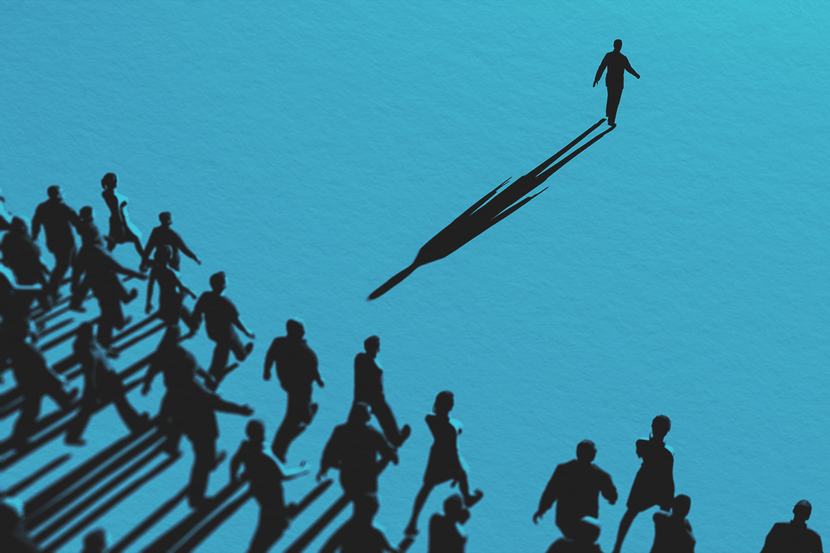 Man standing out it crowd, people following