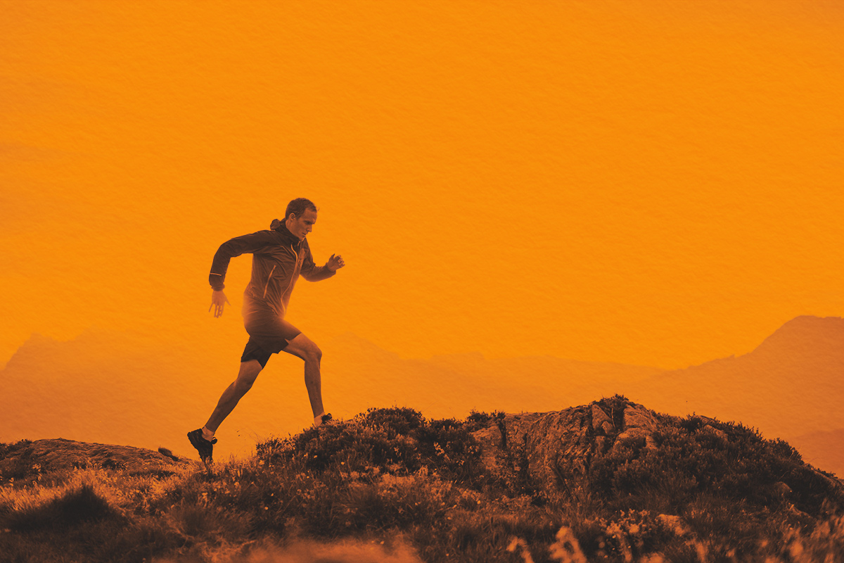 man runs on mountain ridge