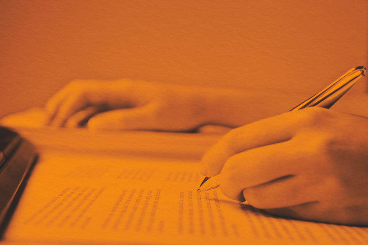 Unrecognizable person reviewing a text