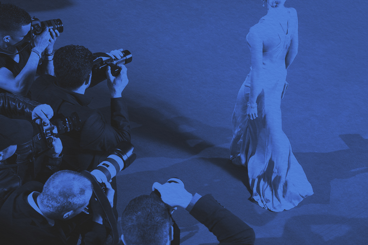 Paparazzi taking pictures of celebrity on red carpet