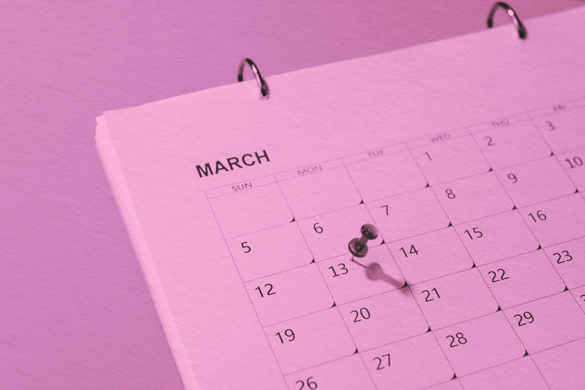 Red push pin on 13th day of March marked in calendar