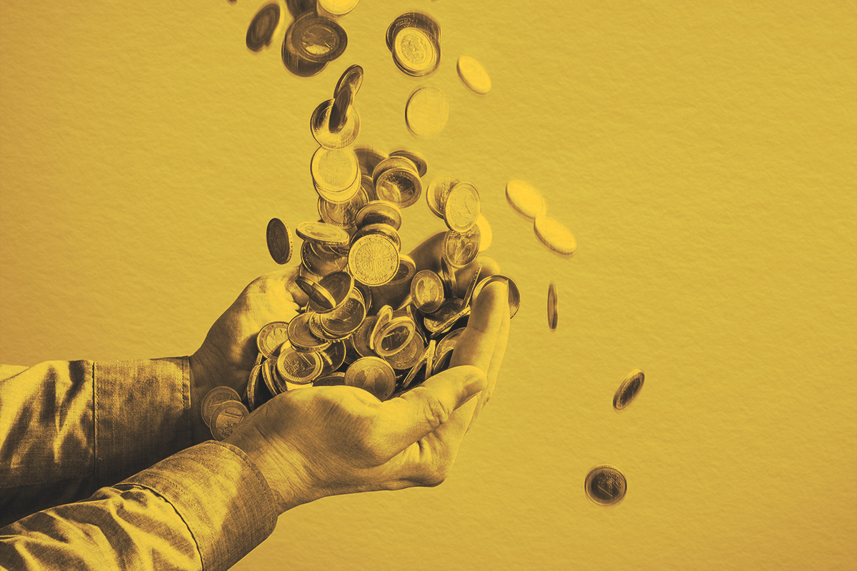 Money coins raining into human hands