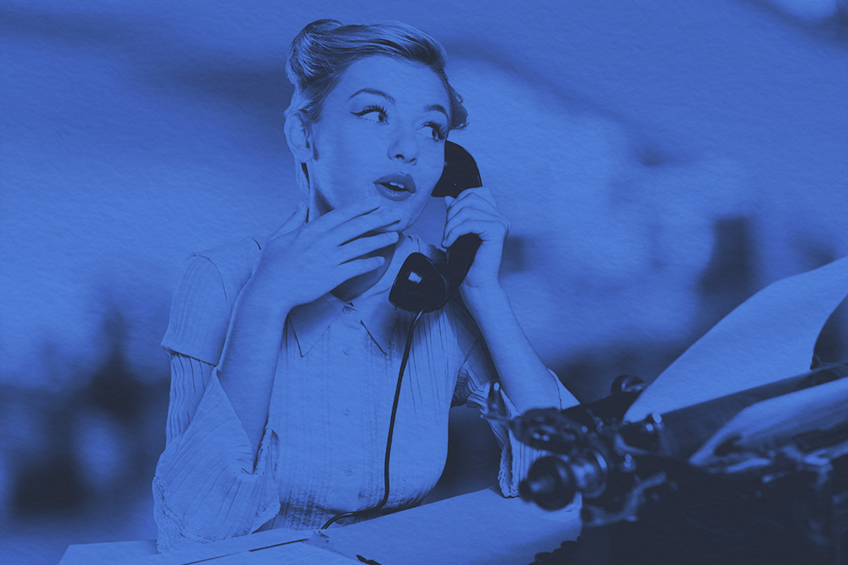 Young woman speaking on vintage phone