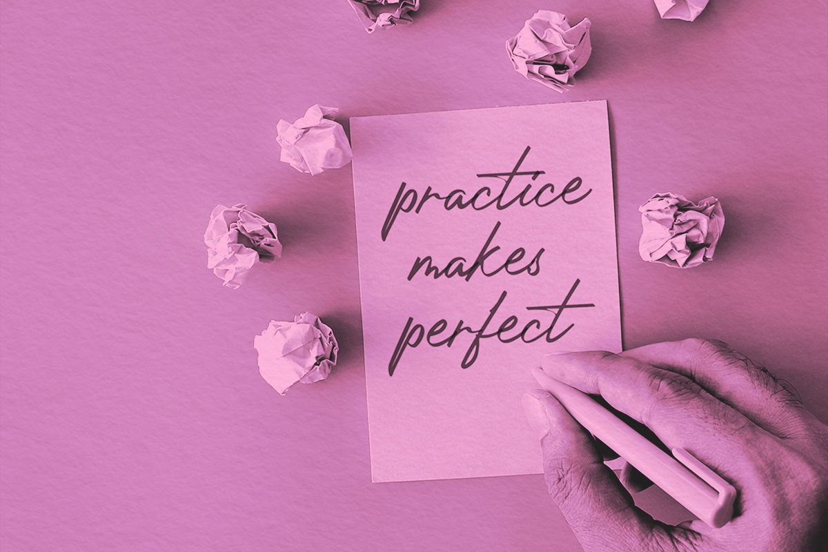 crumpled paper balls and a paper with text PRACTICE MAKES PERFECT