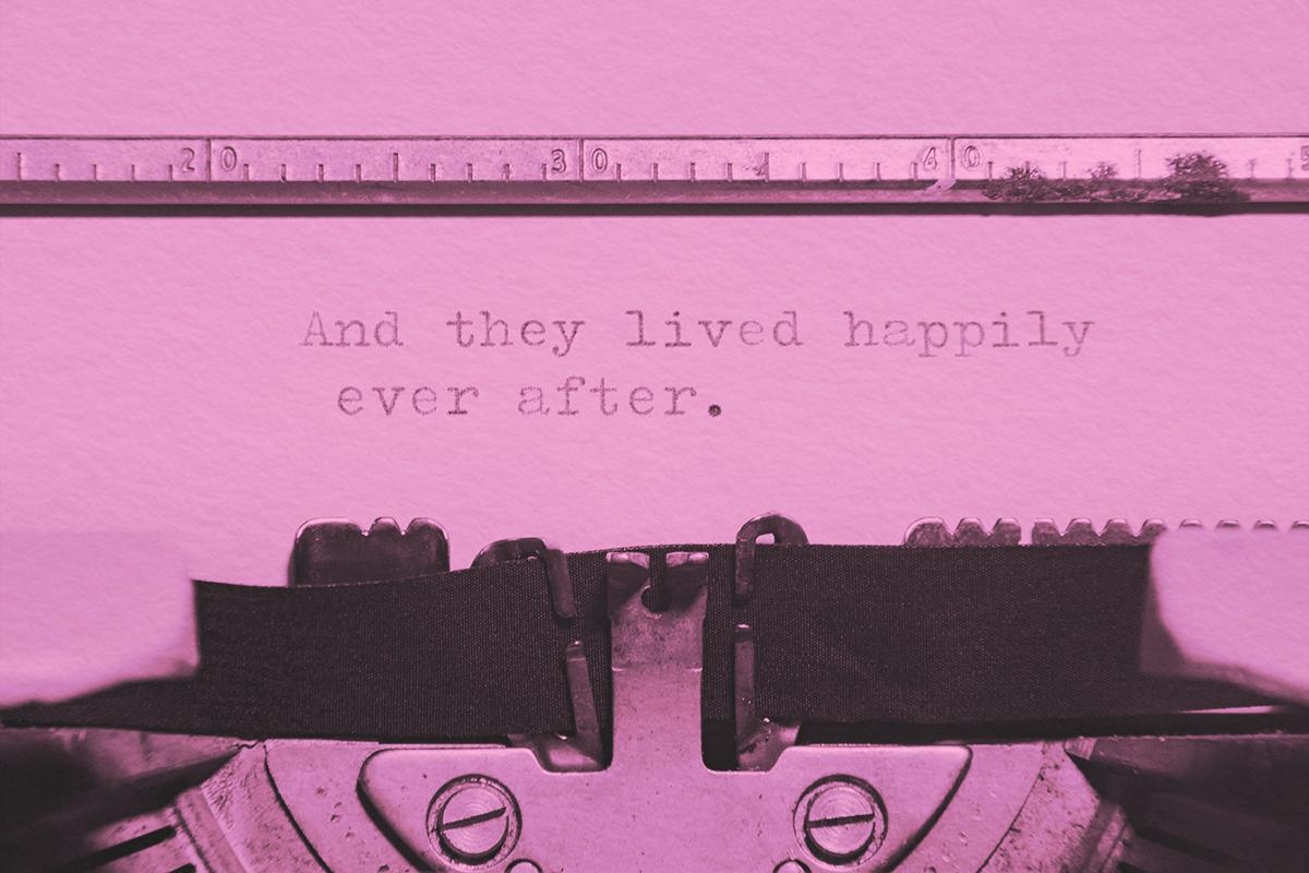 Phrase And they lived happily ever after, printed on a paper inside an old vintage typewriter