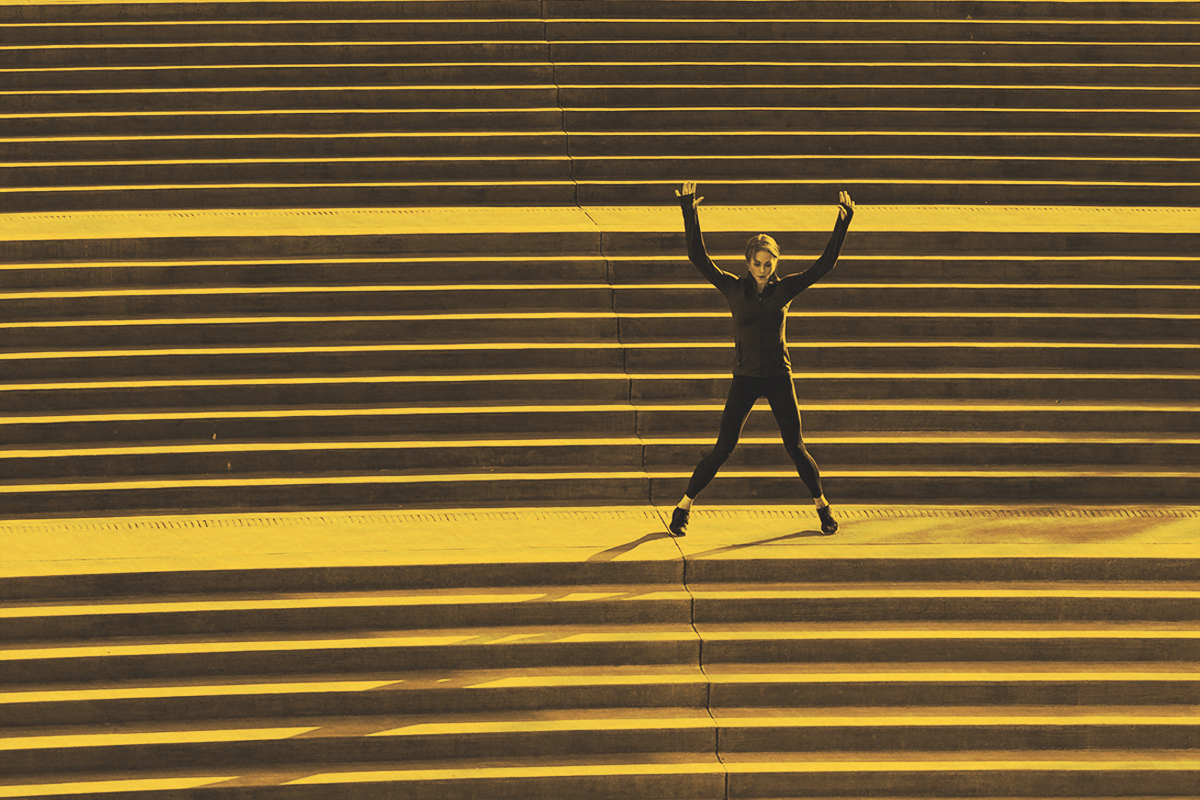 Woman doing jumping jacks on stairs