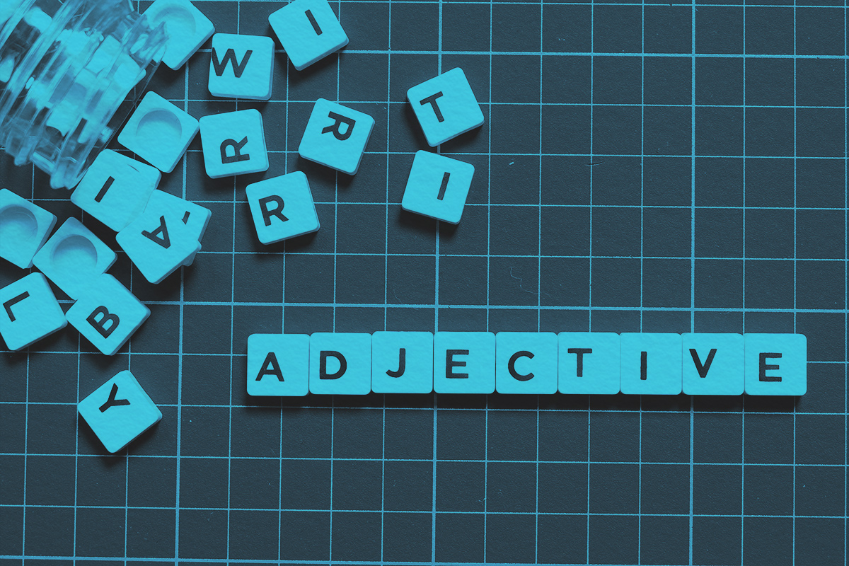 Adjective word made of square letters on square mat background