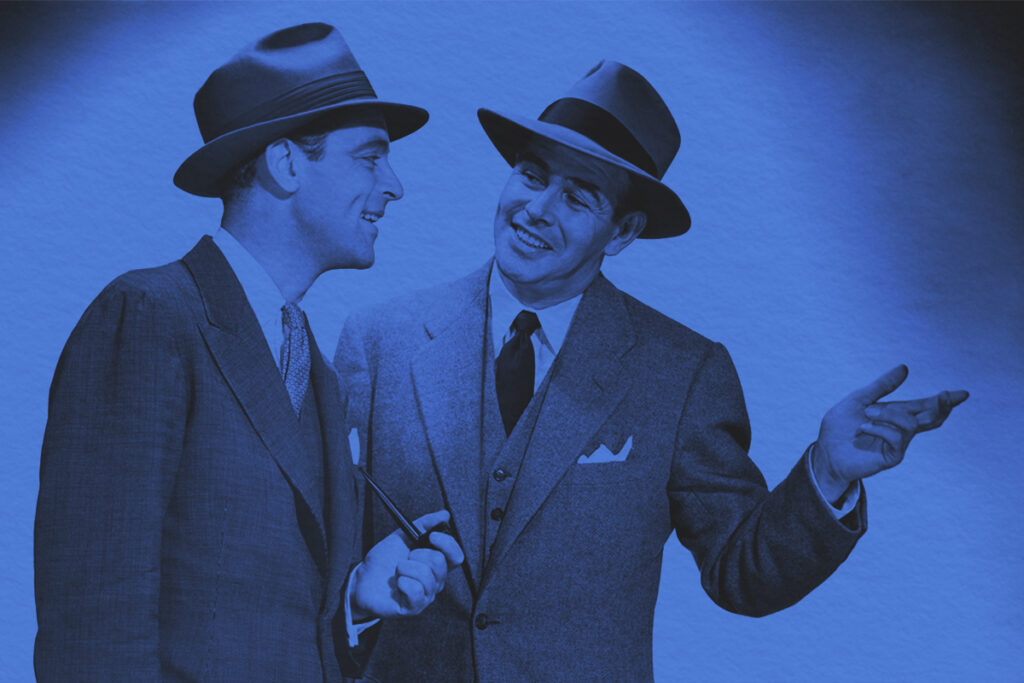 Circa 1950s two male executives conversing