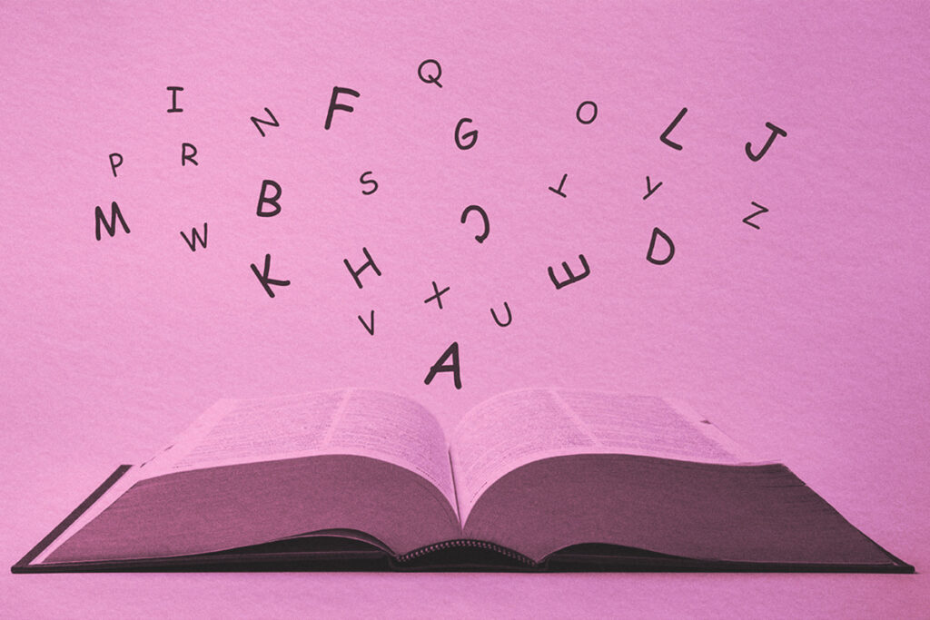 English dictionary with letters flying out of it